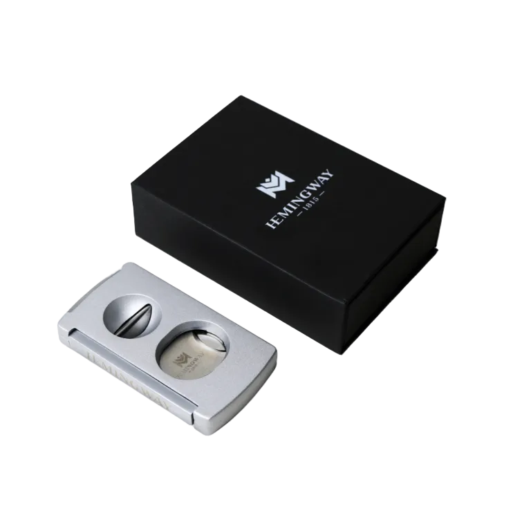 Silver cigar cutter with black box featuring 'Hemingway' brand on a white background