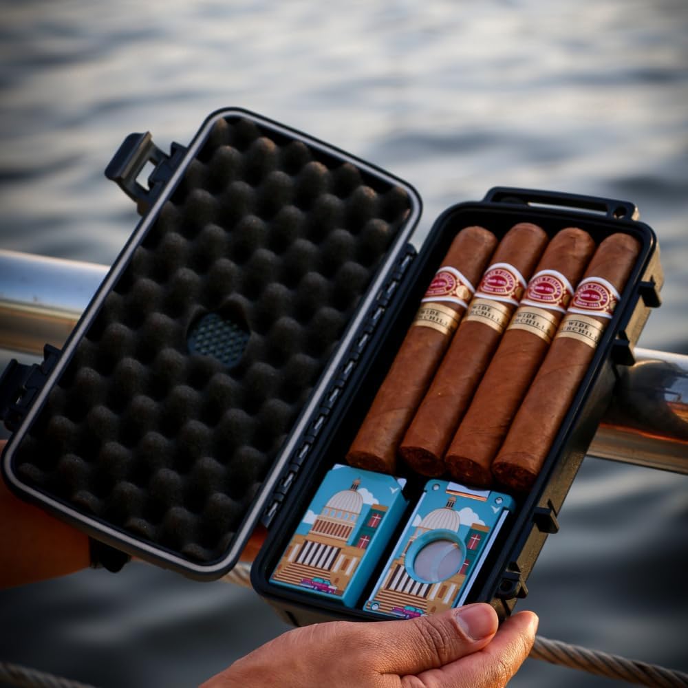 Cigar case with cigars and cards held by a person by a body of water