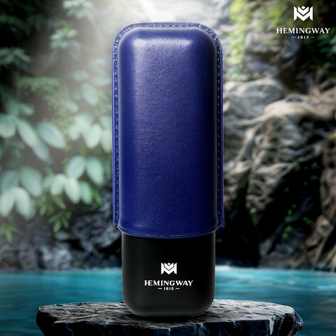 Blue and black leather case with Hemingway logo on a stone surface with a natural background